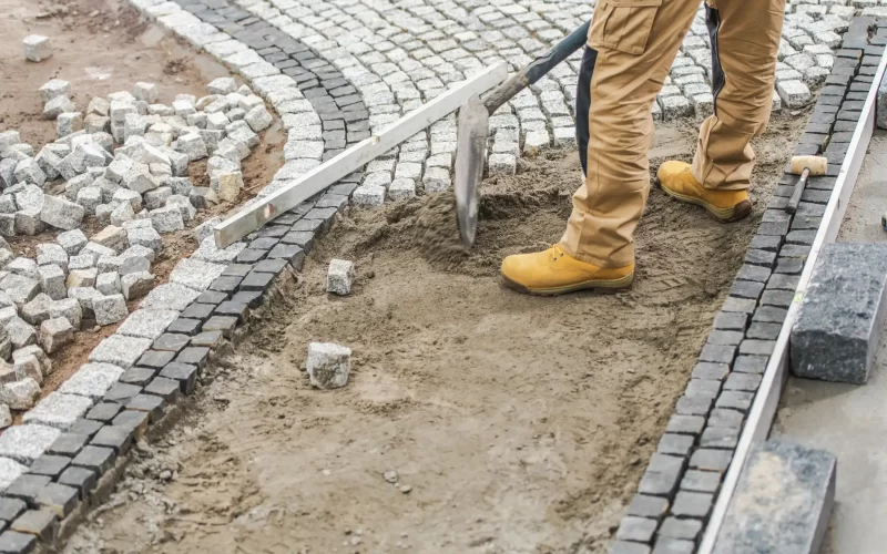 A worker working on the landscape masonry for the home owners garden.